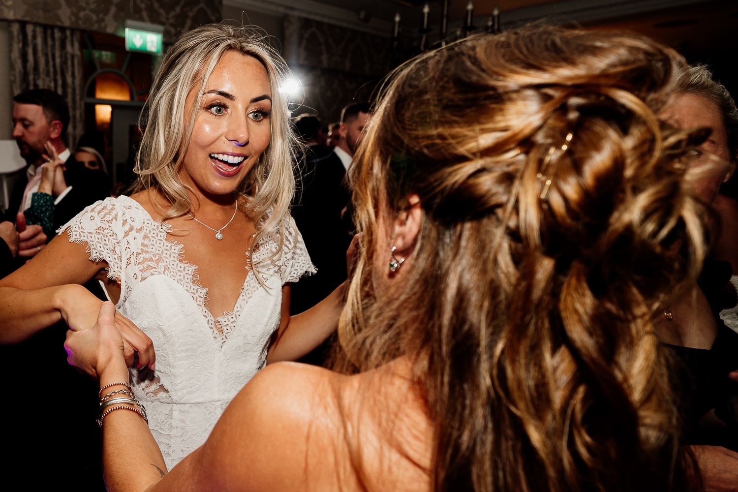 Bride and her friend dancing