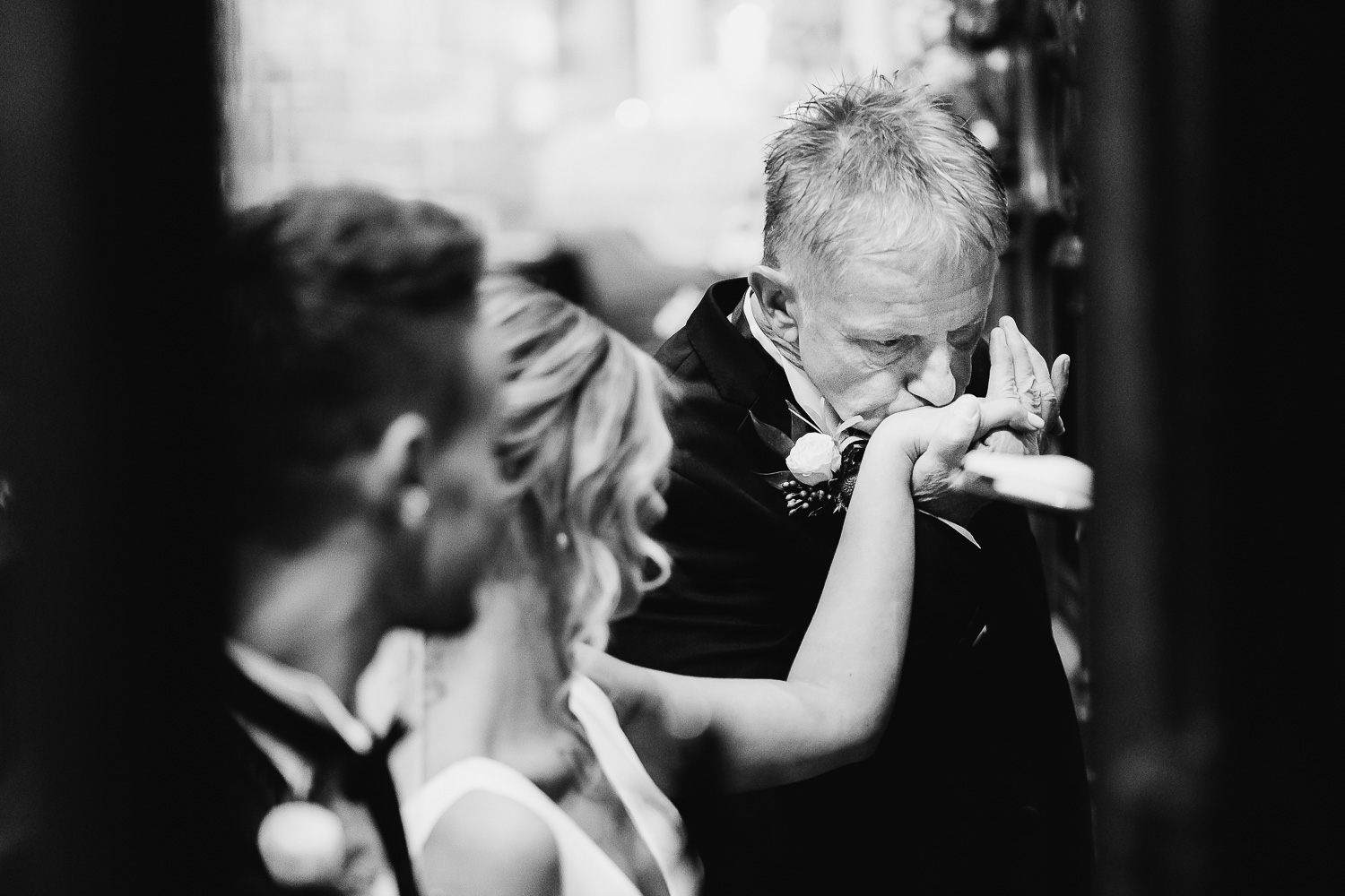 Father of bride kissing her hand