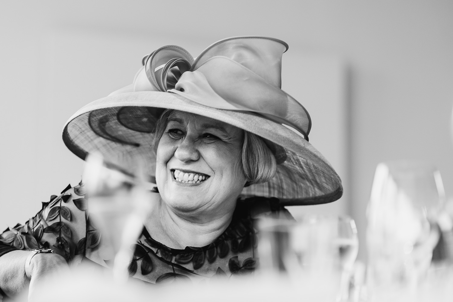 Wedding guest in a hat smiling