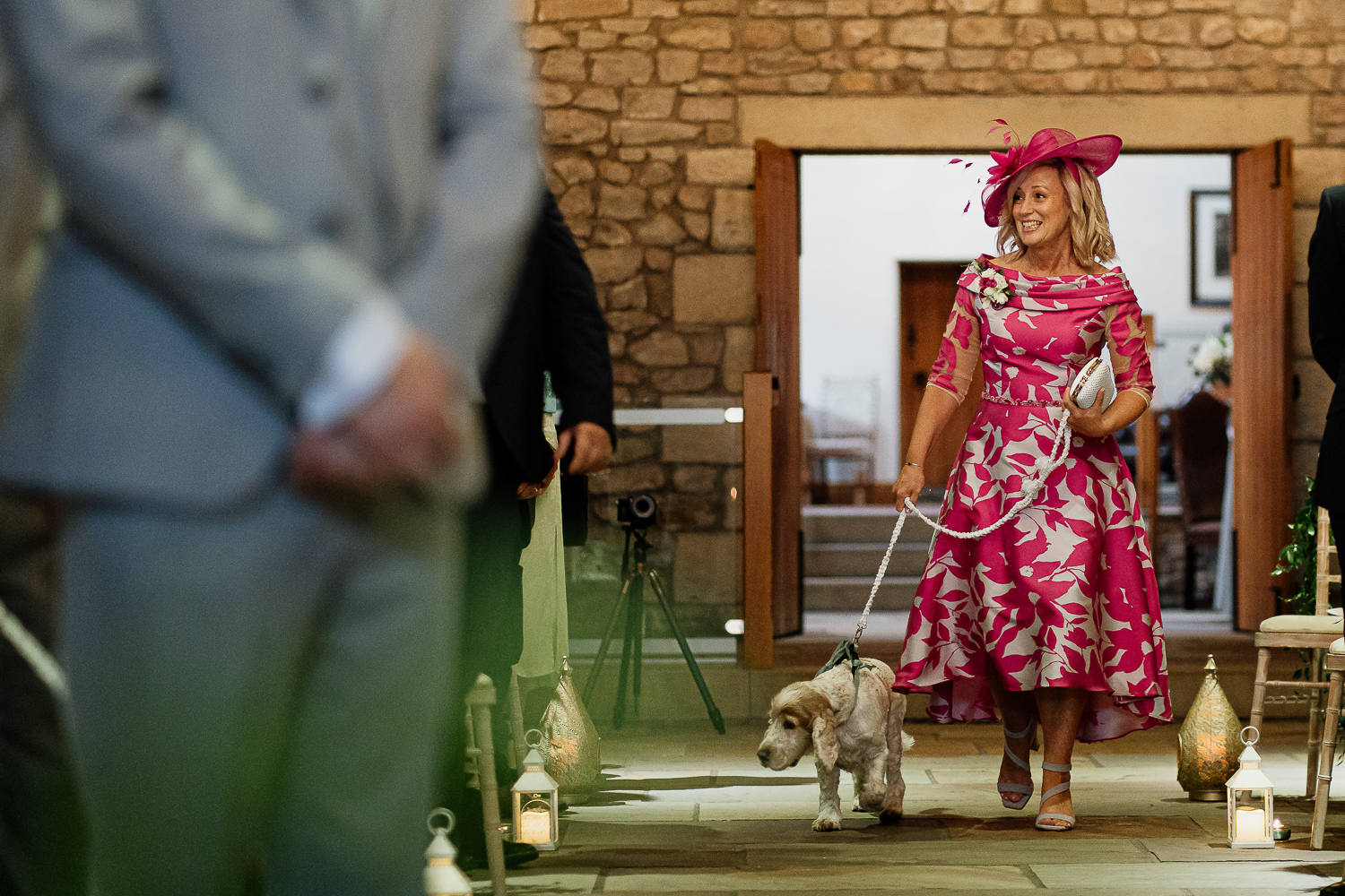 Mother of bride walking down the aisle with a dog