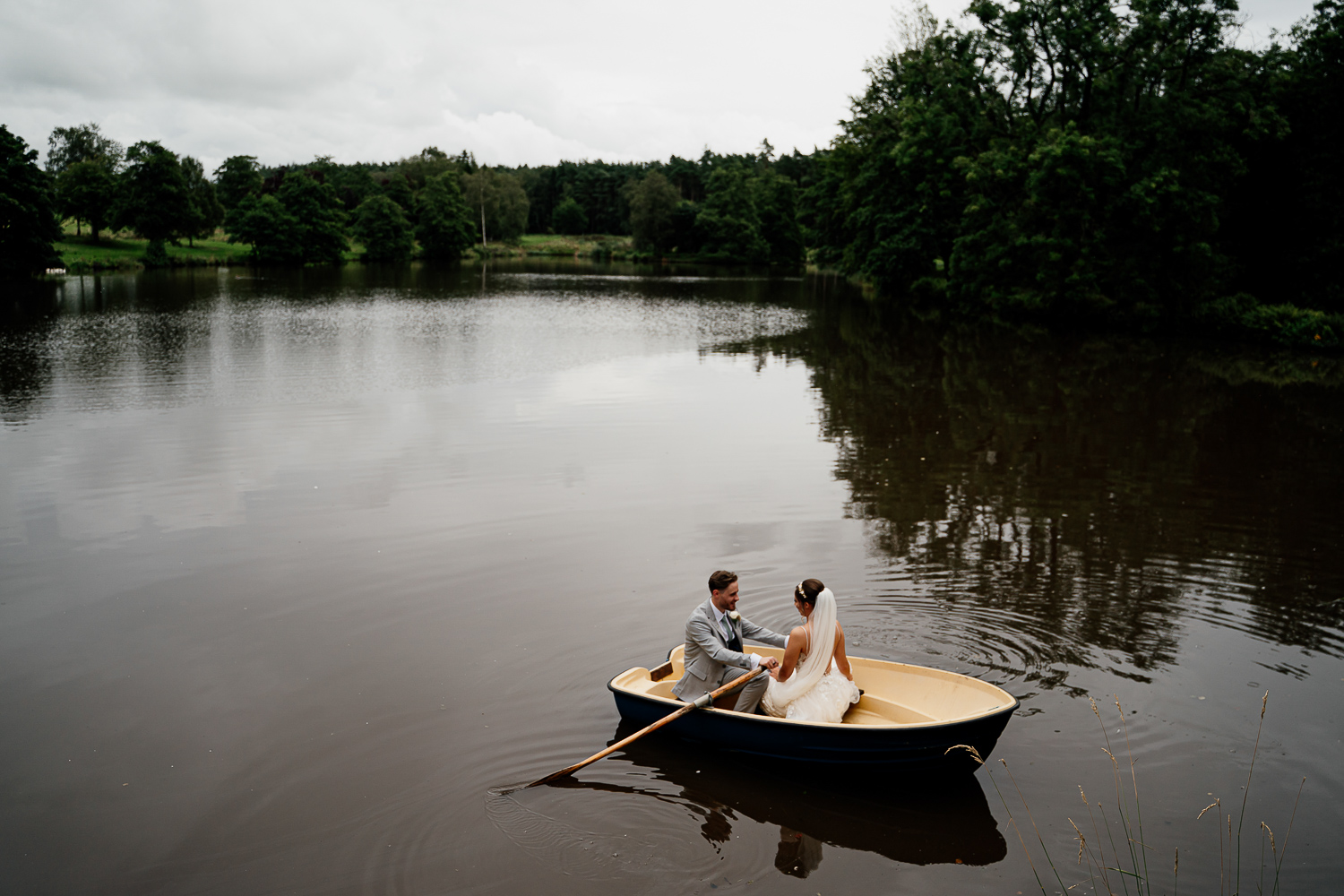 Bride and groom in the boat at Browsholme Tithe Barn