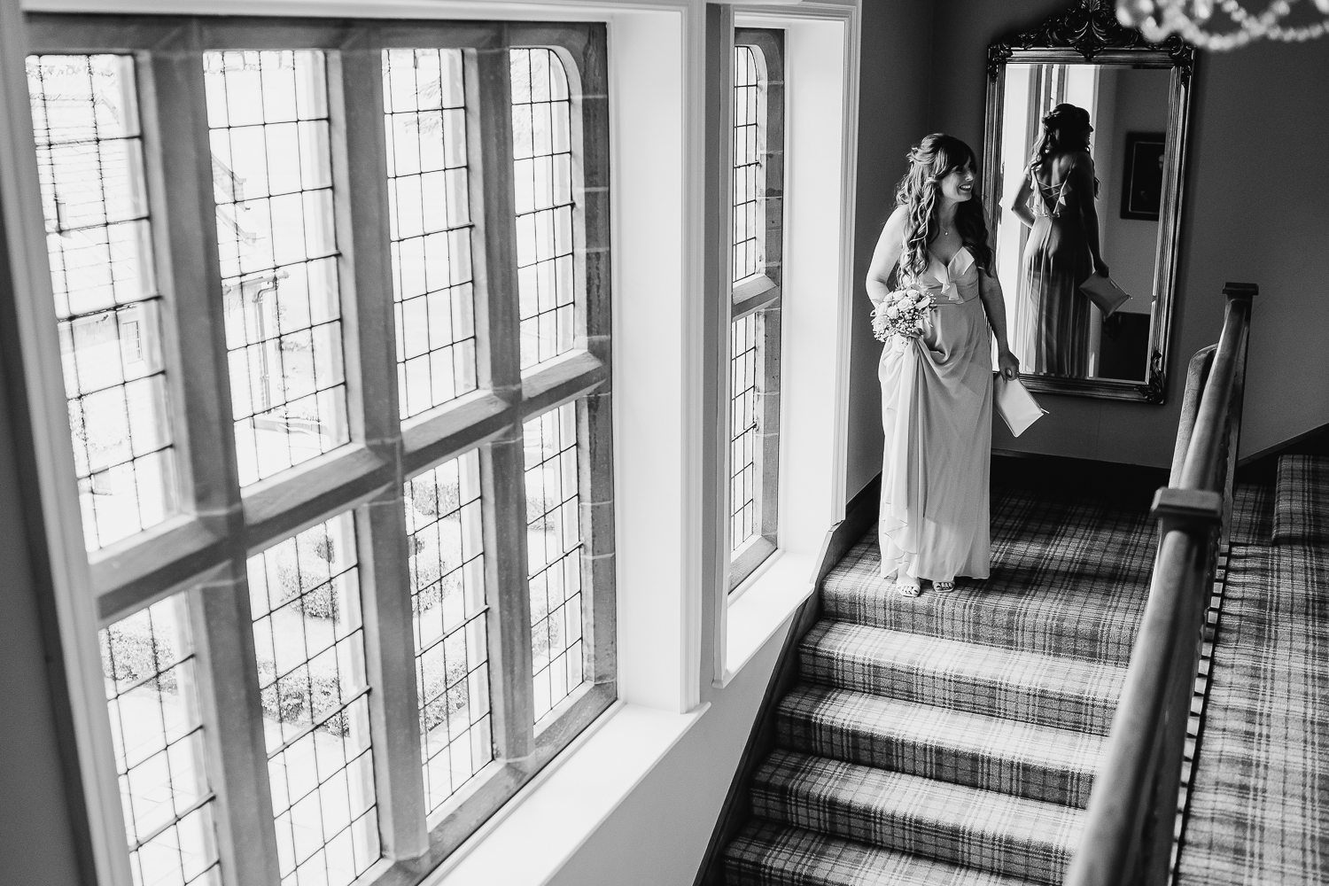 Bridesmaid waiting at top of stairs