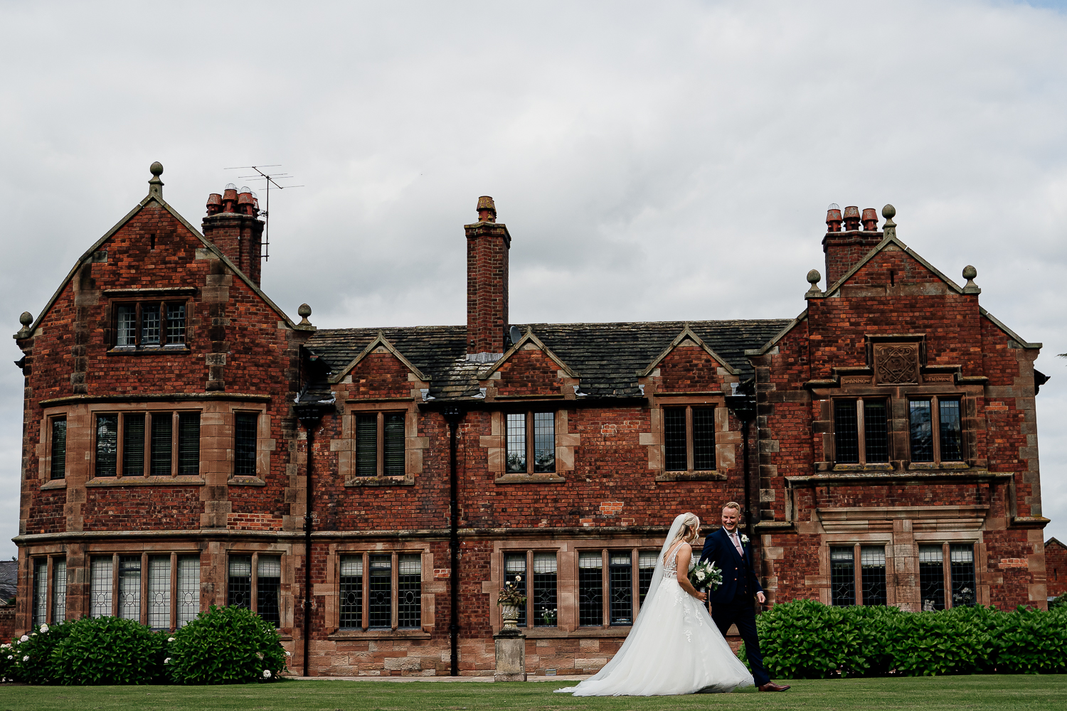 Bride and groom walking at Colshaw Hall