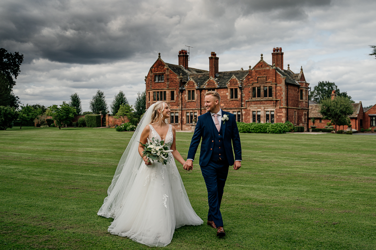 Bride and groom walking at Colshaw Hall