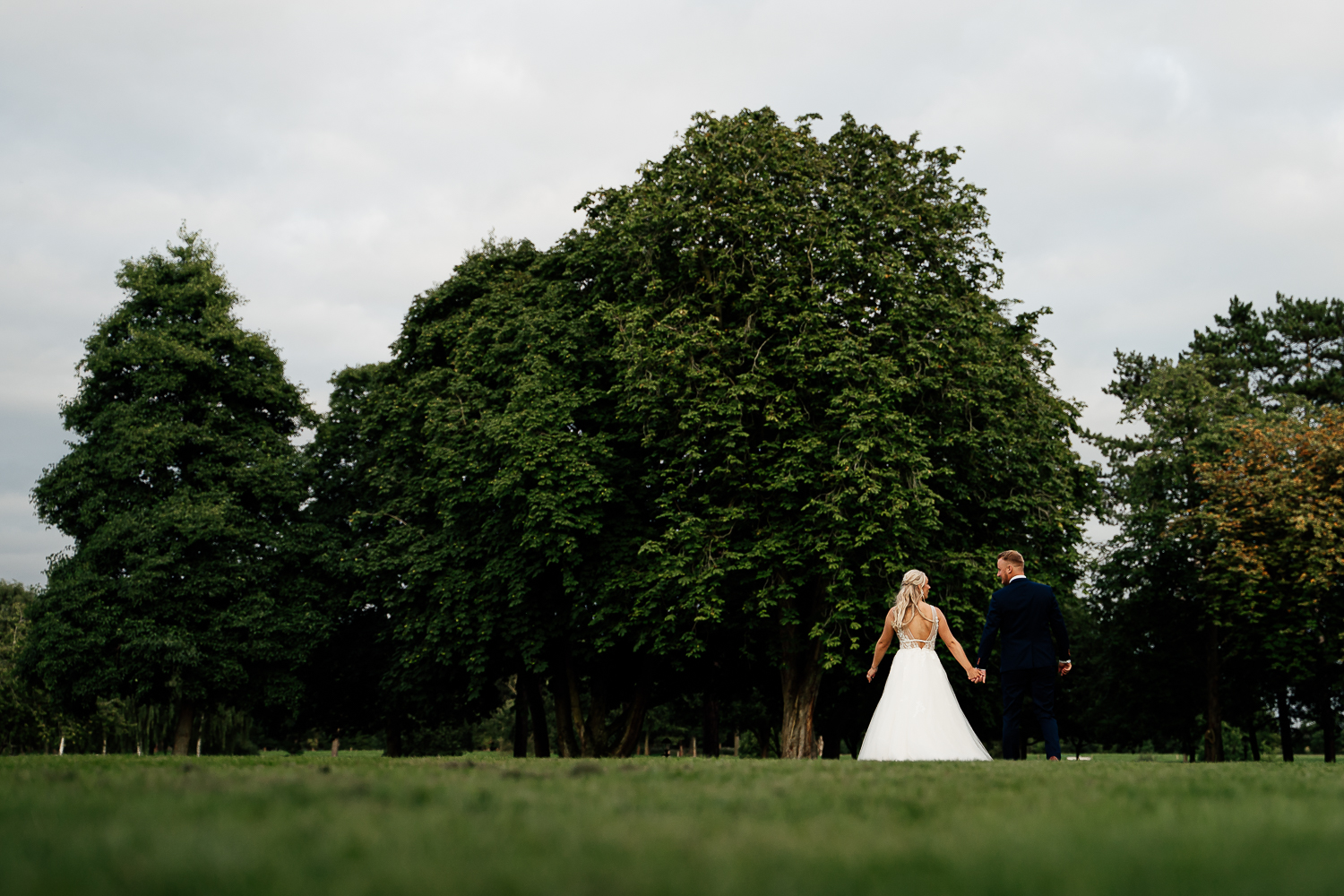 Bride and groom walking together at Colshaw Hall
