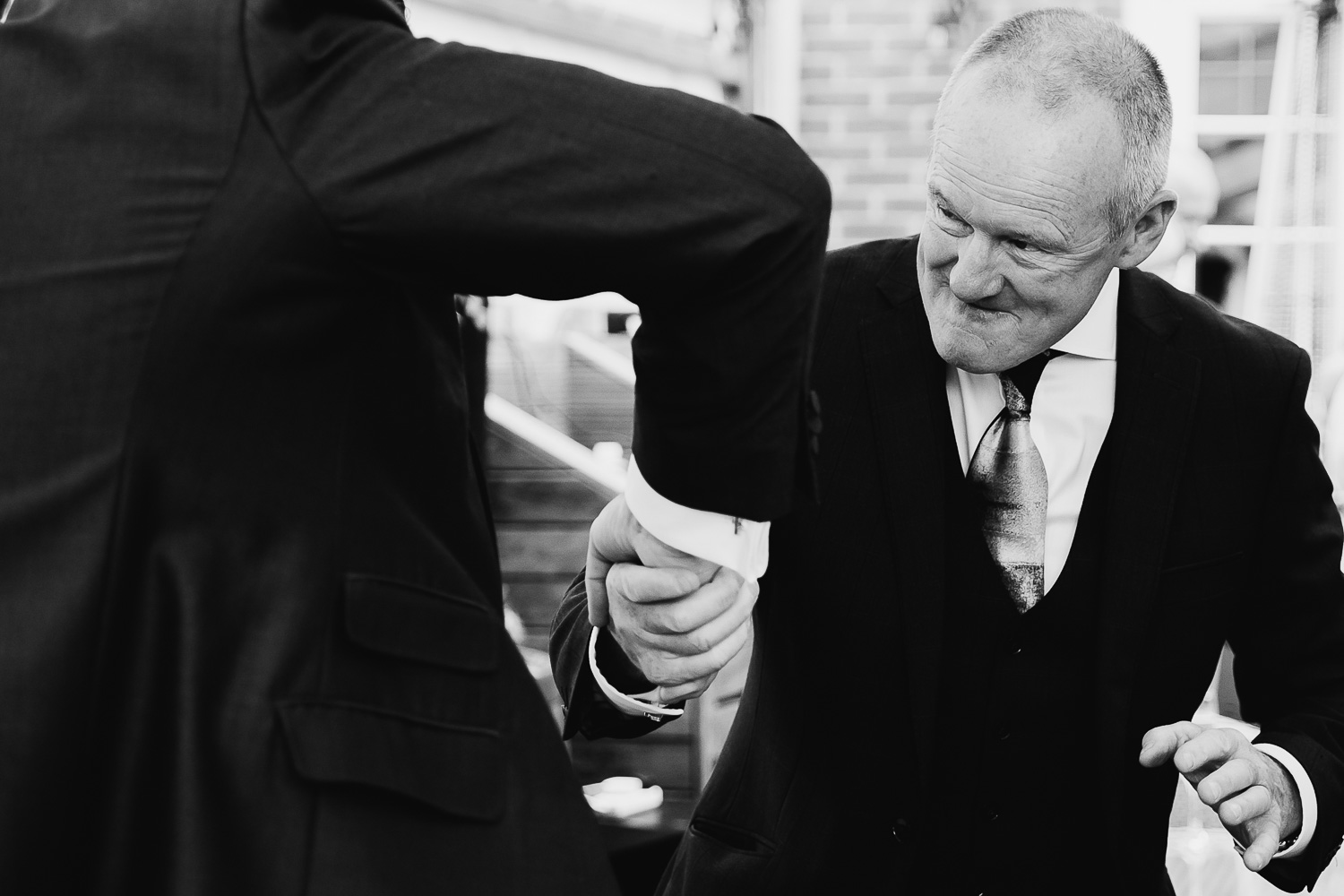 Groom shaking hands with a guest