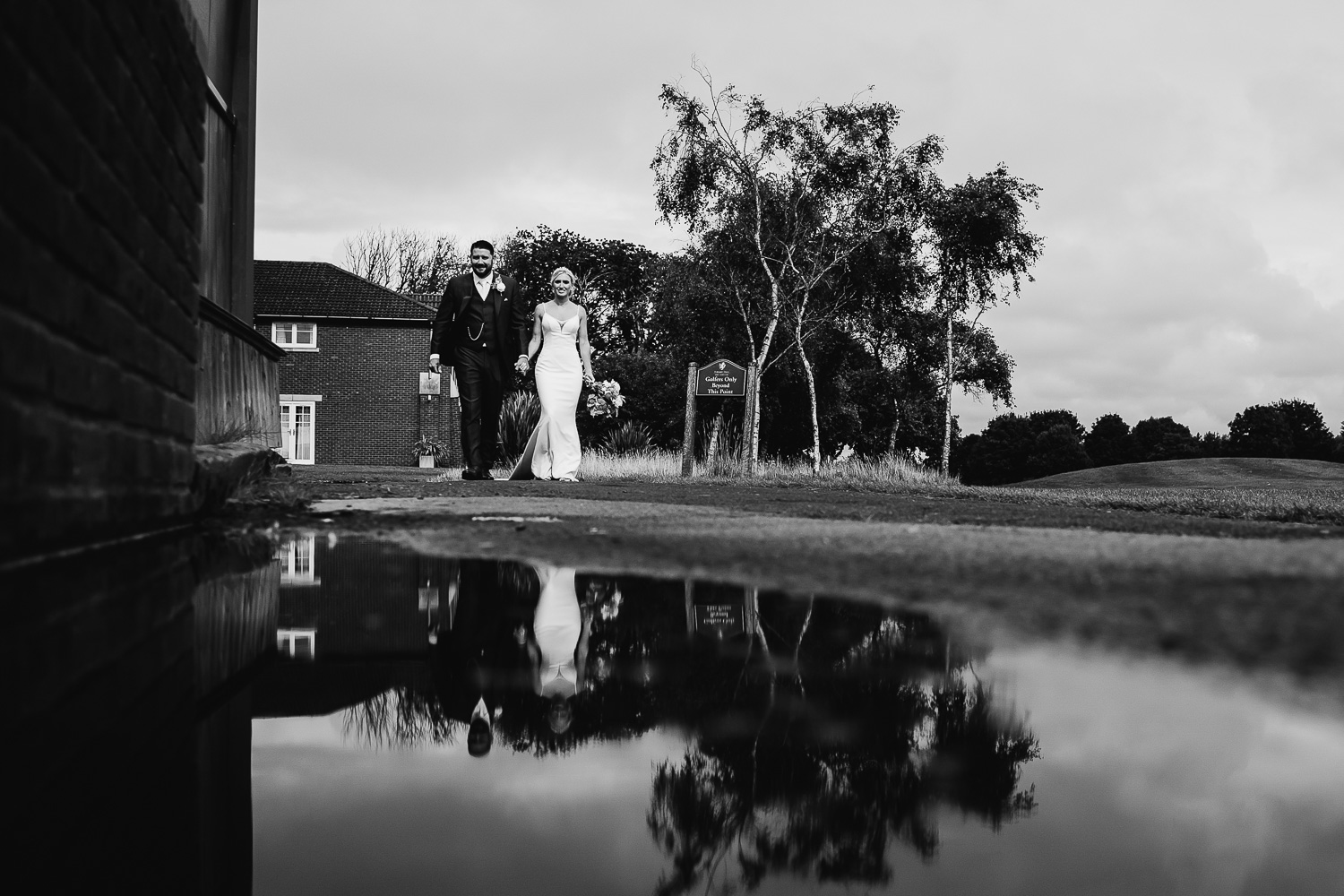 bride and groom walking at Formby Hall