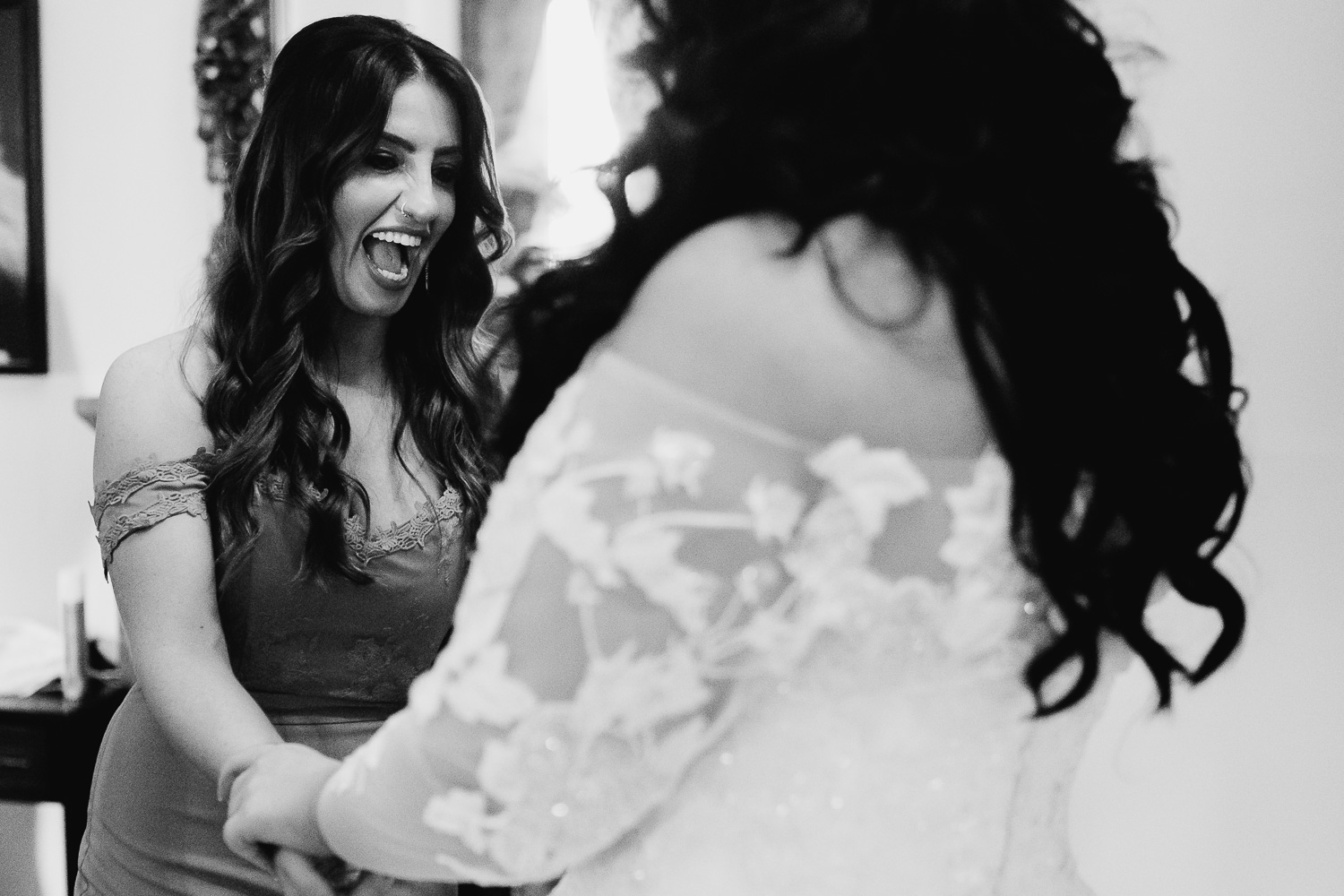 Bride laughing with bridesmaid