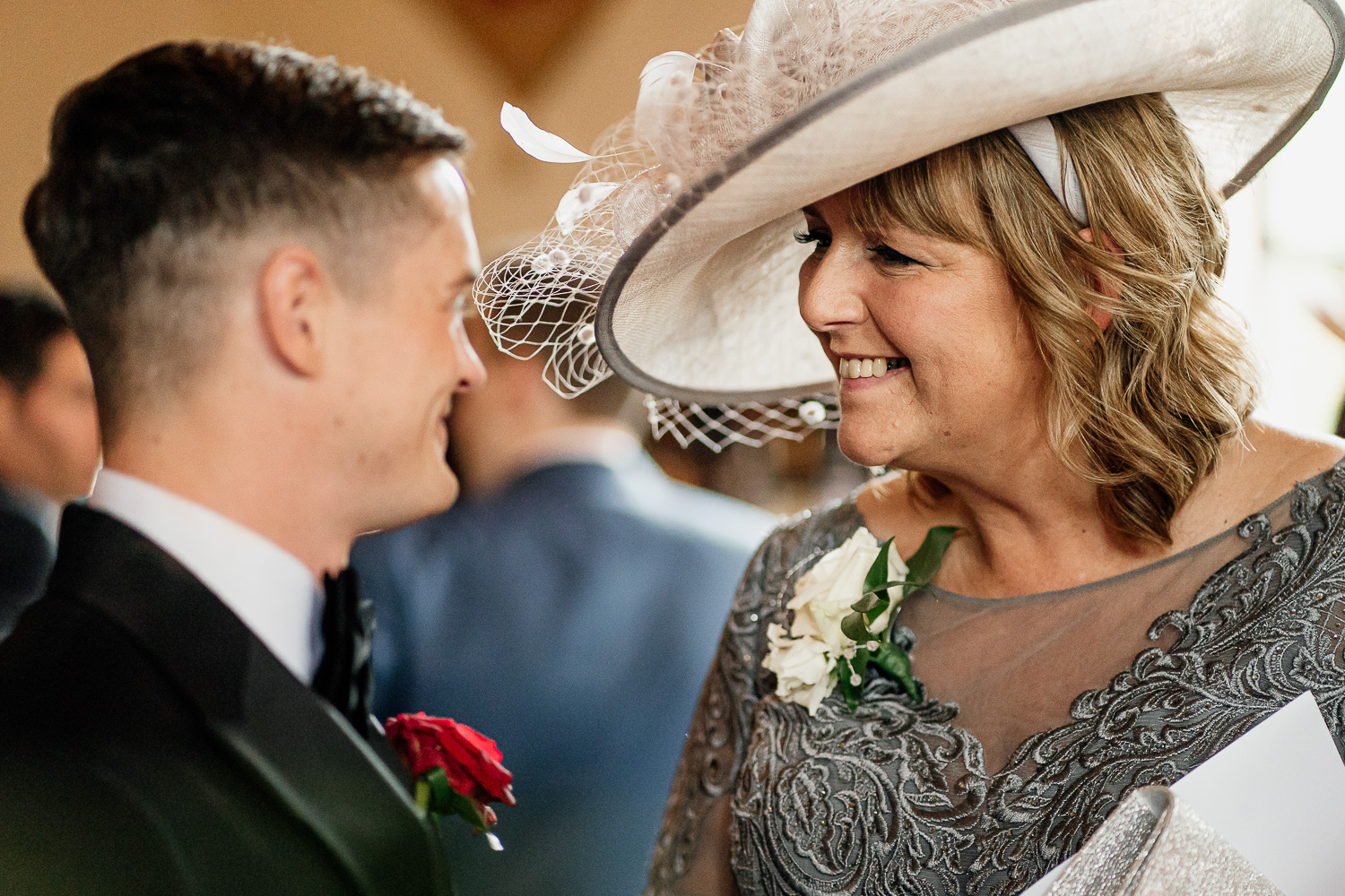 Groom smiling with mother of bride