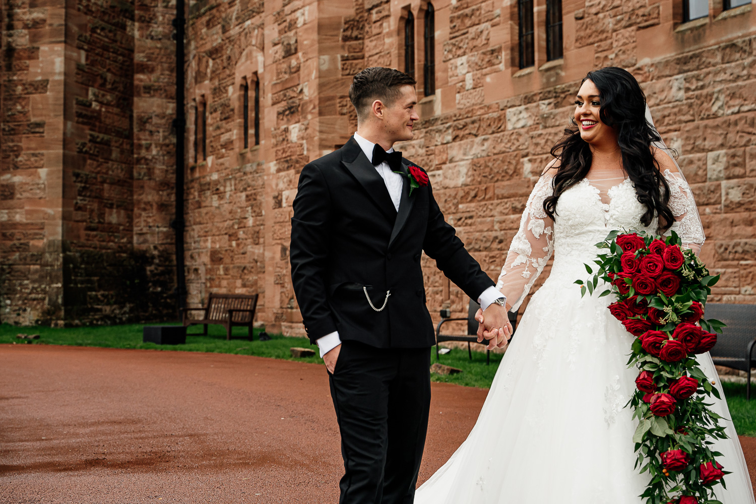 Bride and groom walking at Peckforton Castle