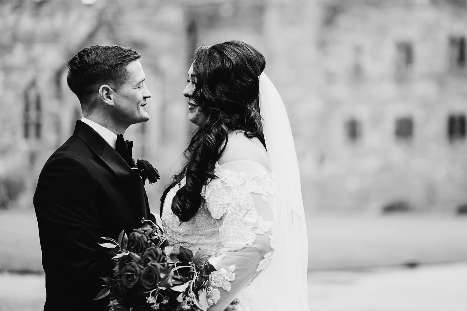 Bride and groom laughing at Peckforton Castle