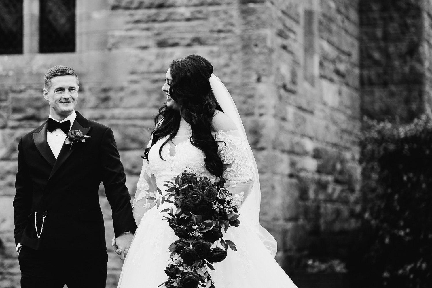 Bride and groom walking at Peckforton castle