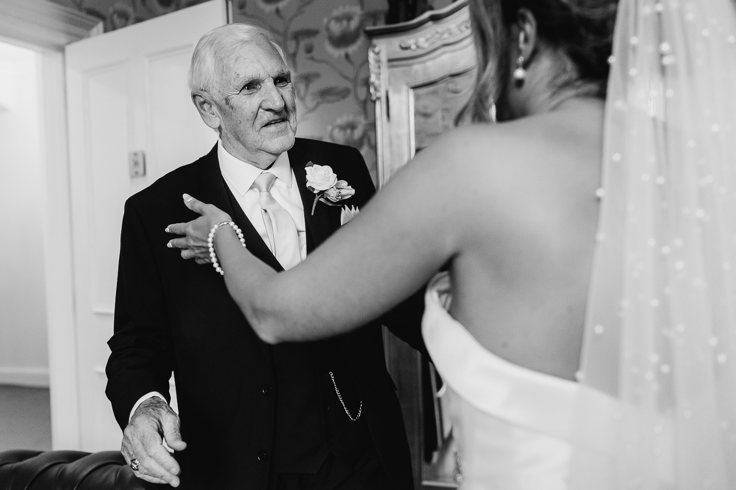 Bride and father of bride about to hug