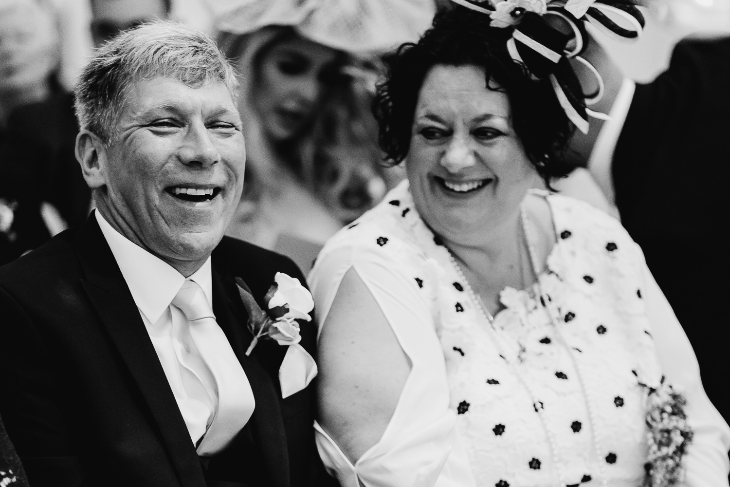 Grooms parents laughing in the ceremony