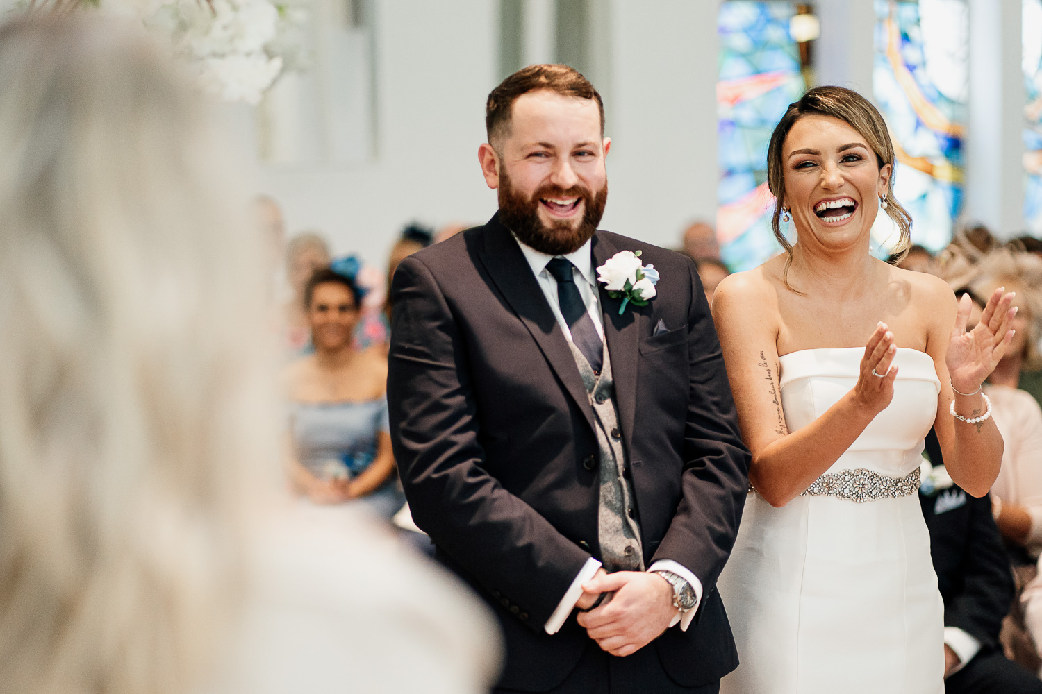 Bride and groom smiling at the reading
