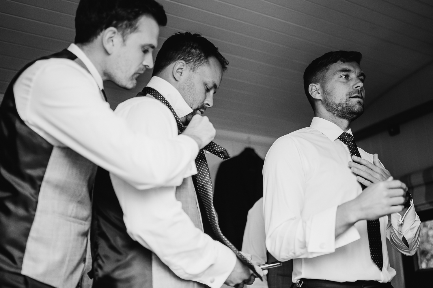 Groom and groomsmen getting dressed