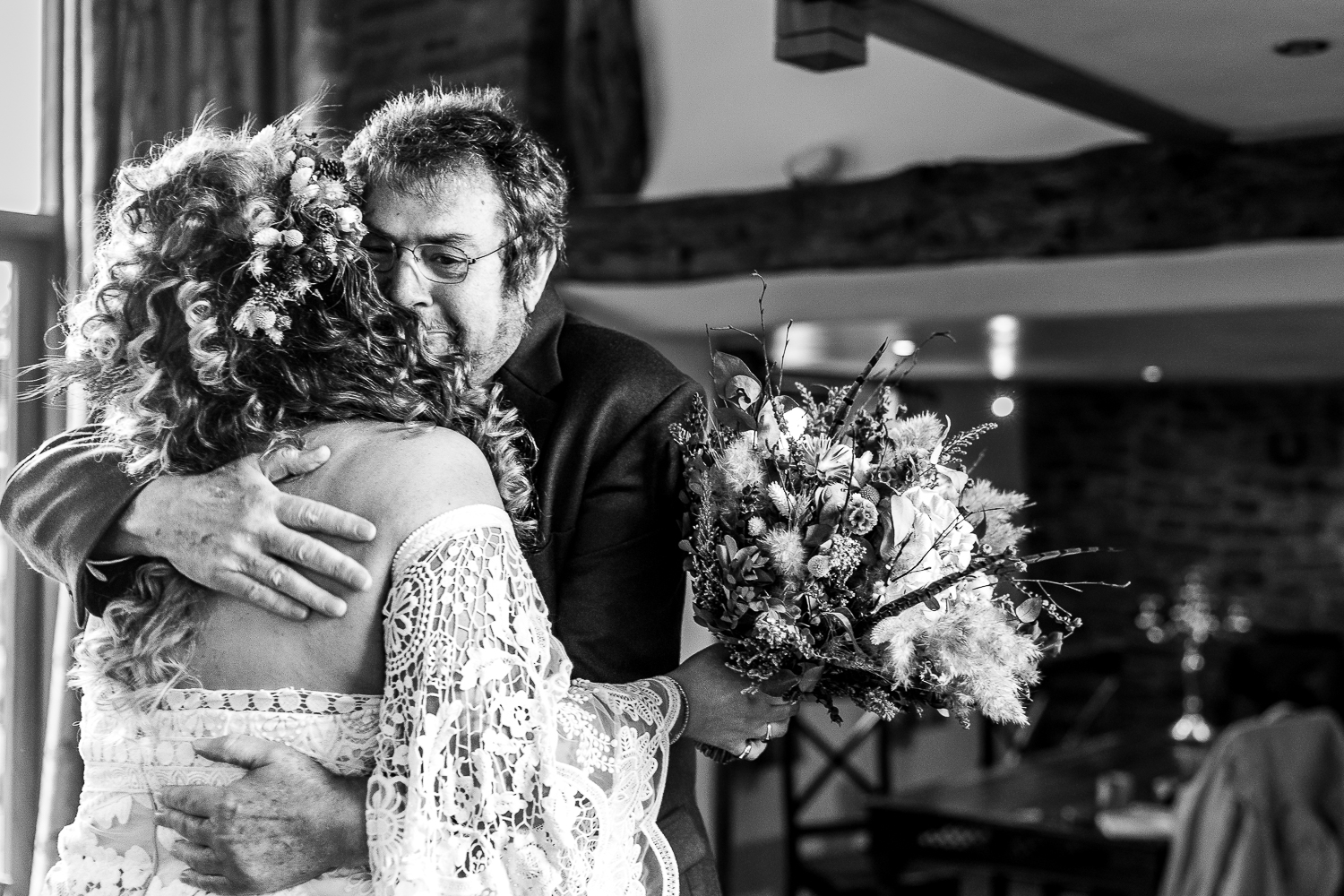 Father of the bride hugging the bride