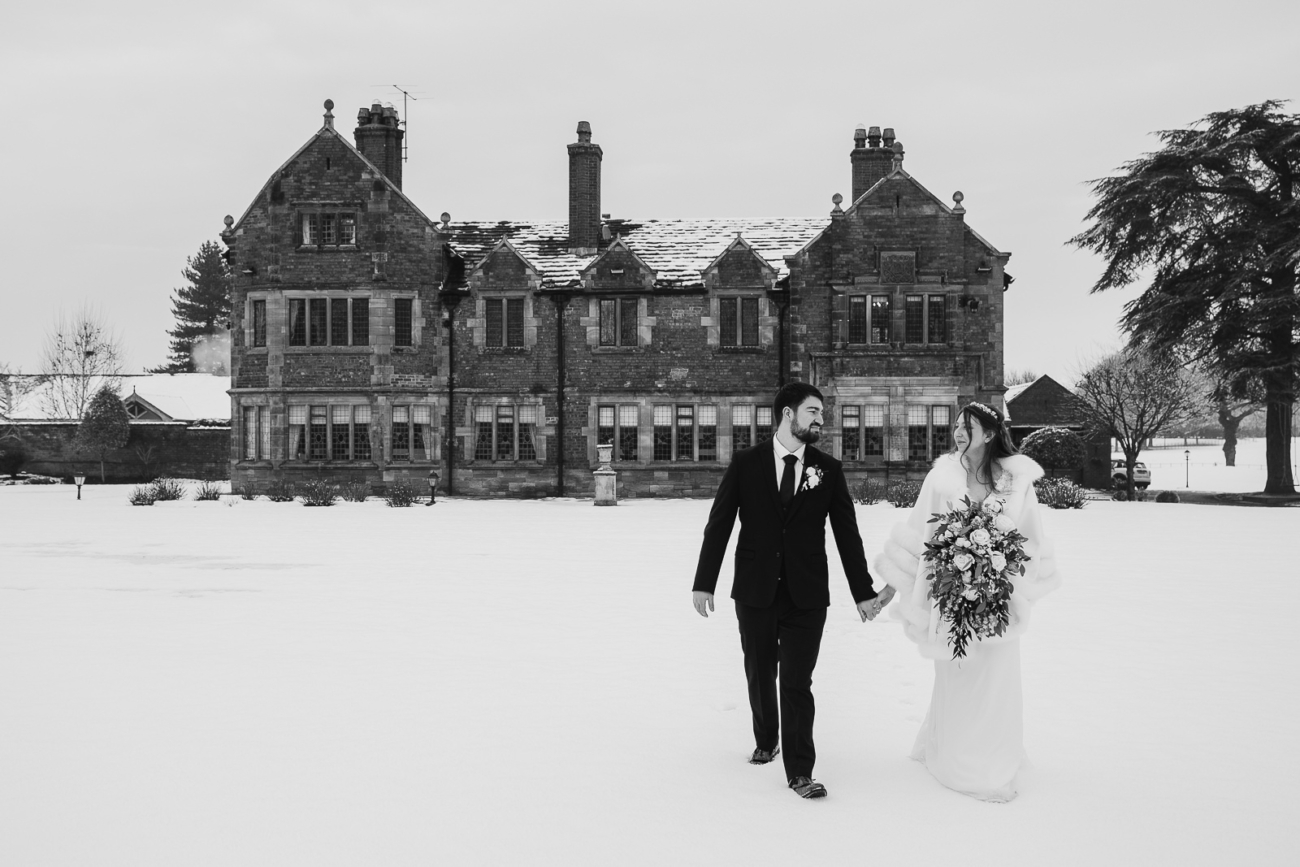 Colshaw Hall winter wedding photo - couple walking in the snow